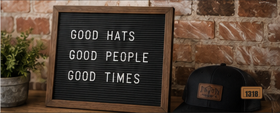 Letterboard reading good hats good people good times beside a custom hat